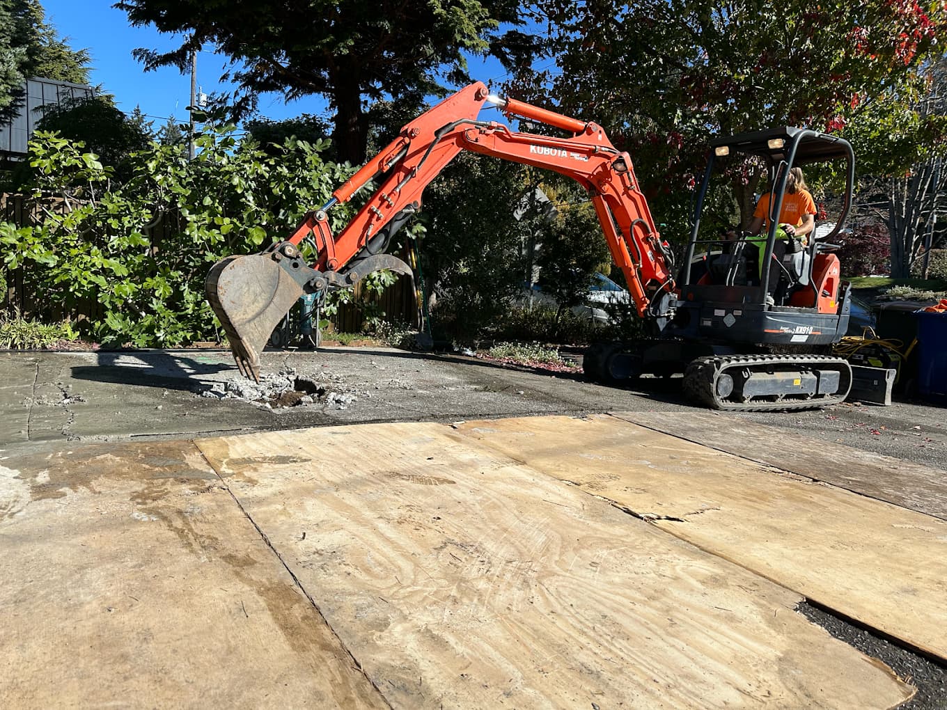 Excavator performing sewer line repair in Seattle